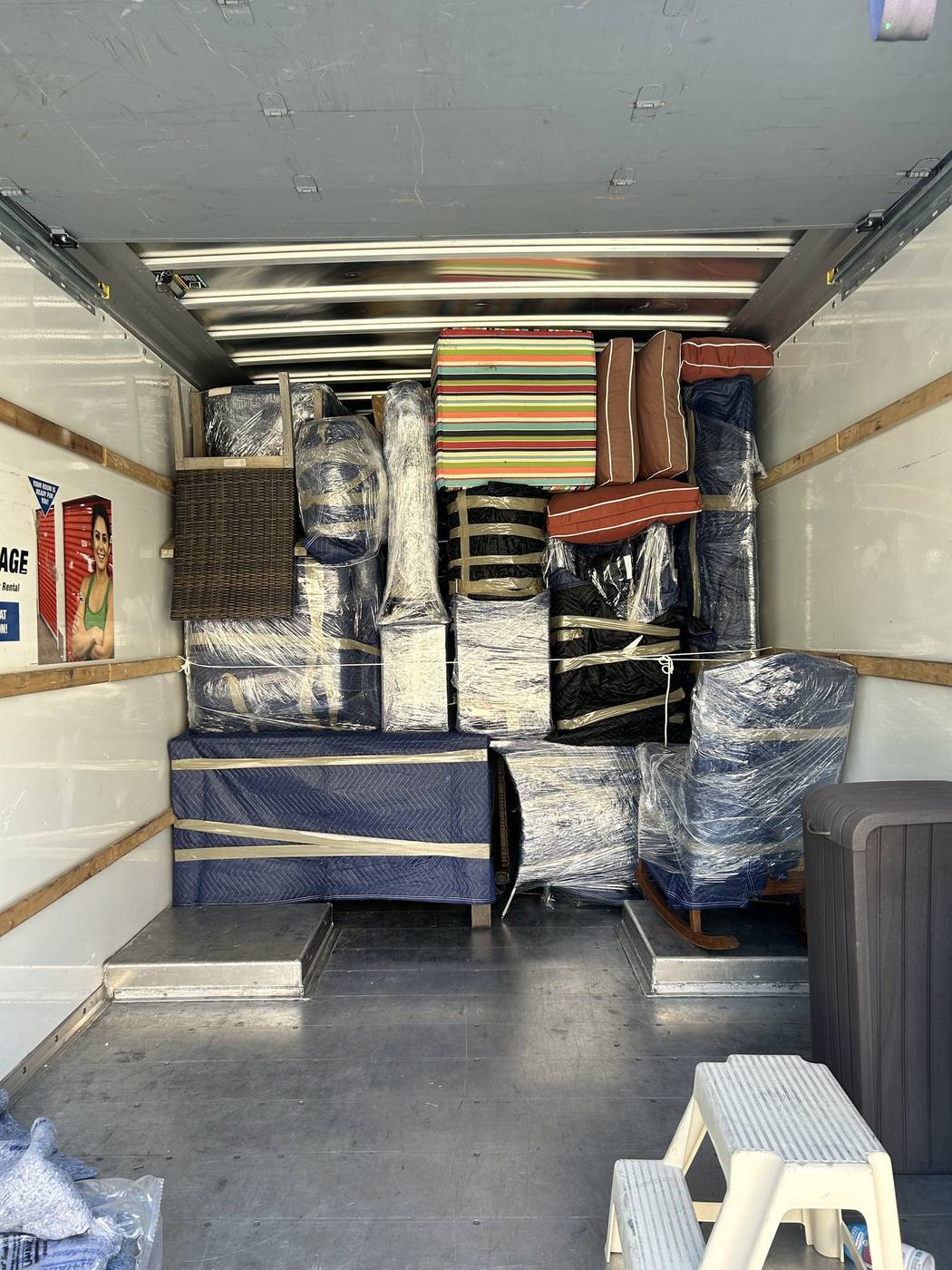The interior of a Just-In Time truck loaded with wrapped furniture and cartons